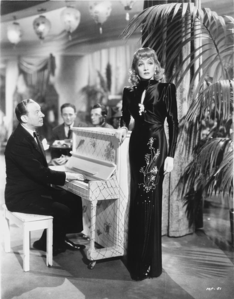 Marlene Dietrich standing elegantly in a black gown photo print.