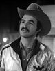 Burt Reynolds film still photo print wearing a cowboy hat.