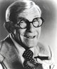 George Burns smoking a cigar photo print in classic black and white.