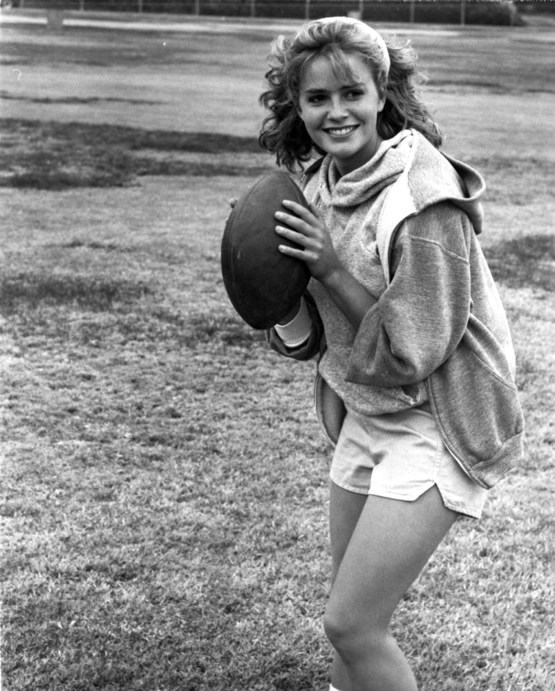 Classic photo print of Elizabeth Shue holding a football.