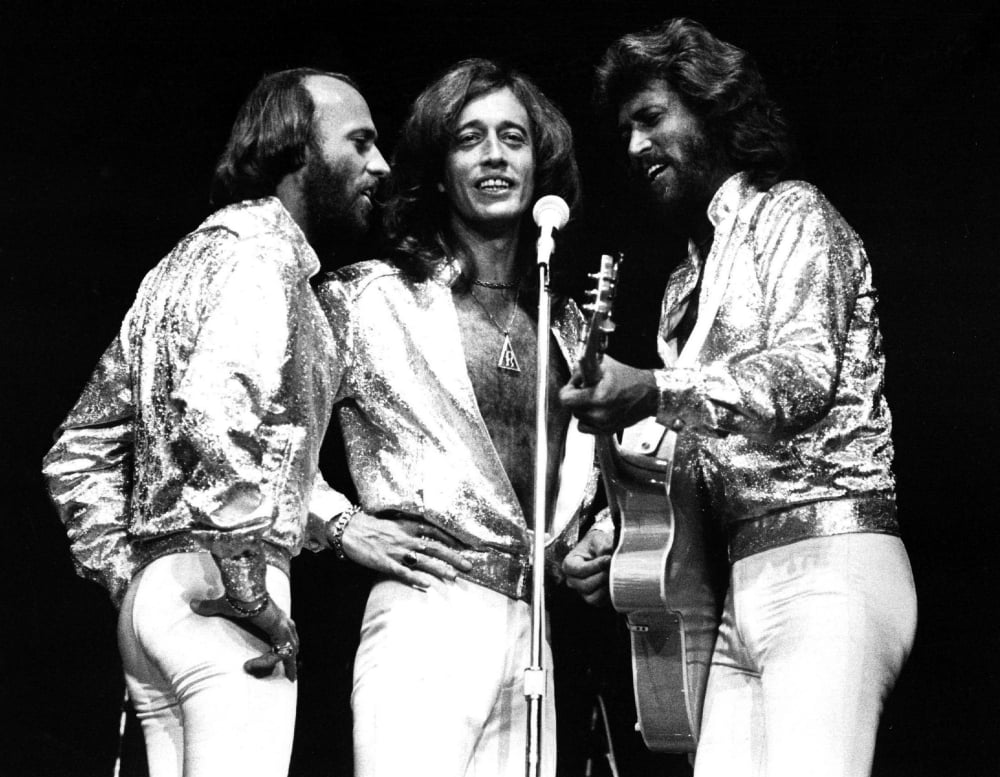 The Bee Gees live performance photo print capturing their iconic stage presence.
