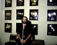 Maurice Gibb photo print in front of platinum records