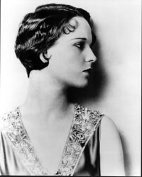 Louise Brooks black and white photo print profile against wall.