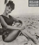 Dawn Wells sitting on a beach photo print
