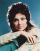 Suzanne Pleshette in a long sleeve dress on a blue background photo print.