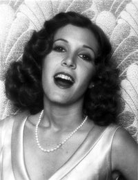 Carrie Fisher elegant photo print in silk dress with necklace on printed background.