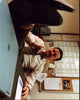 Ricky Gervais photo print with feet on desk, perfect for office decor.