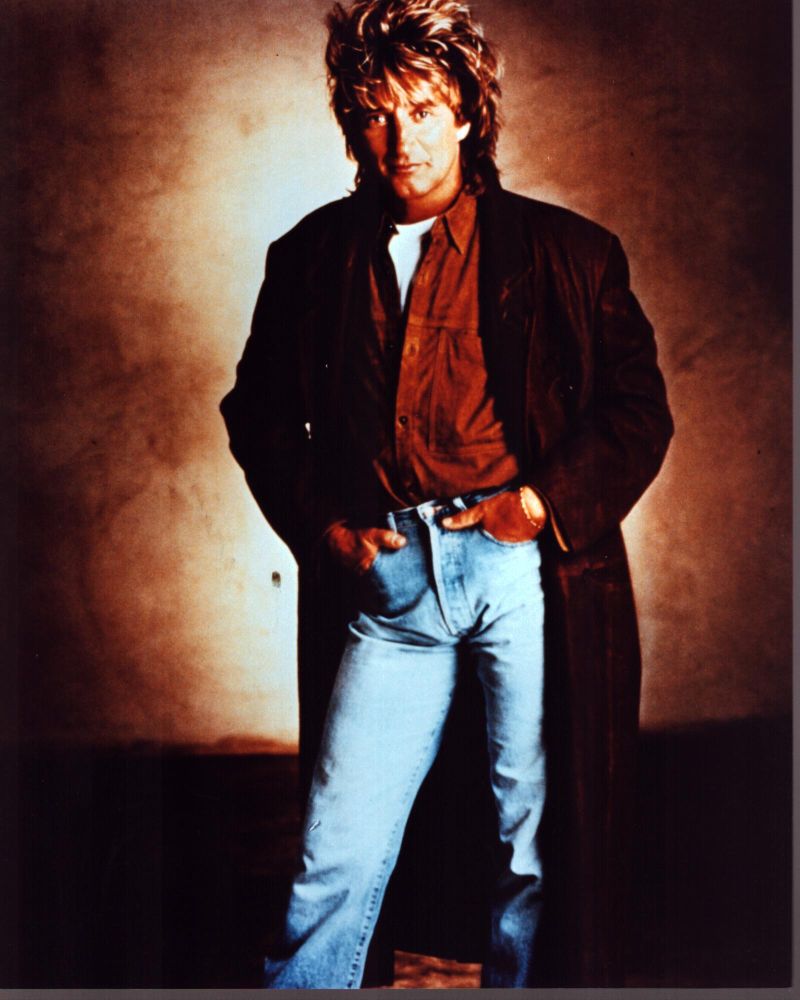 Rod Stewart photo print in a long brown coat with hands in pockets.