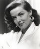 Jane Russell portrait photo print in white linen suit and gold hoop earrings.