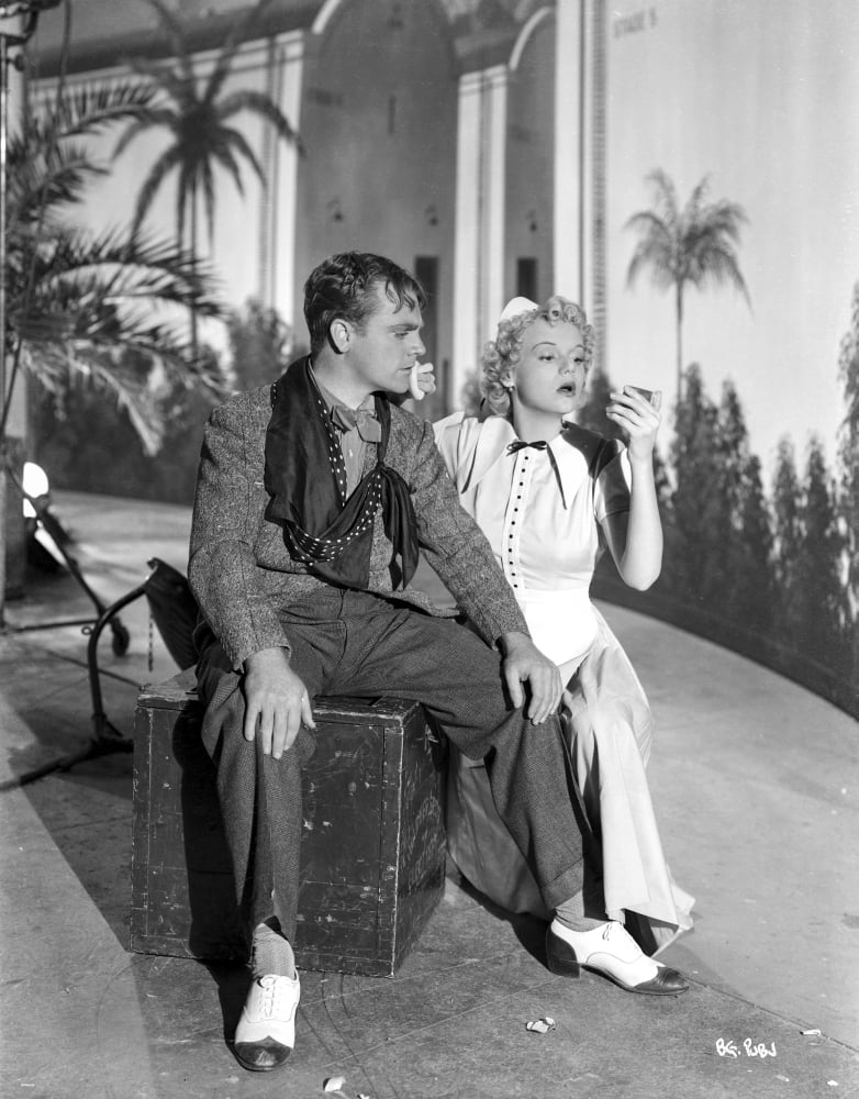 Film still photo print of James Cagney and co-star sitting on a box.