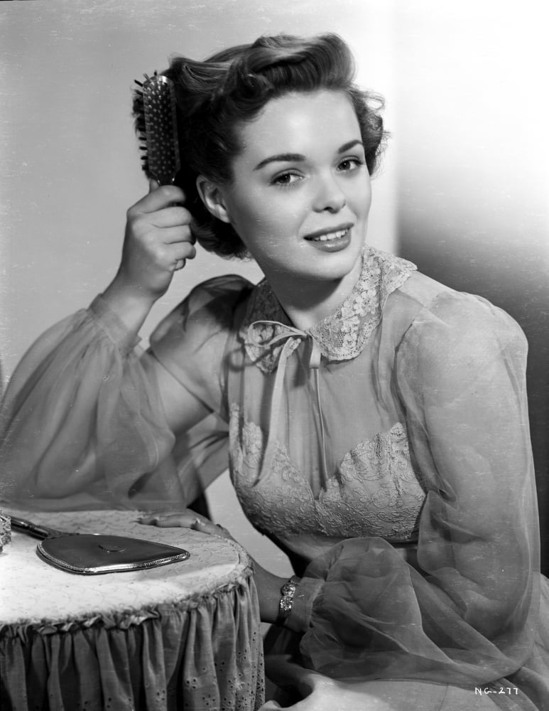 Nancy Gates posed in an elegant see-through long sleeve outfit photo print.