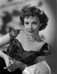 Laraine Day vintage black and white photo print wearing a necklace and black dress.