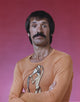 Sonny Bono posed in orange long sleeve shirt photo print