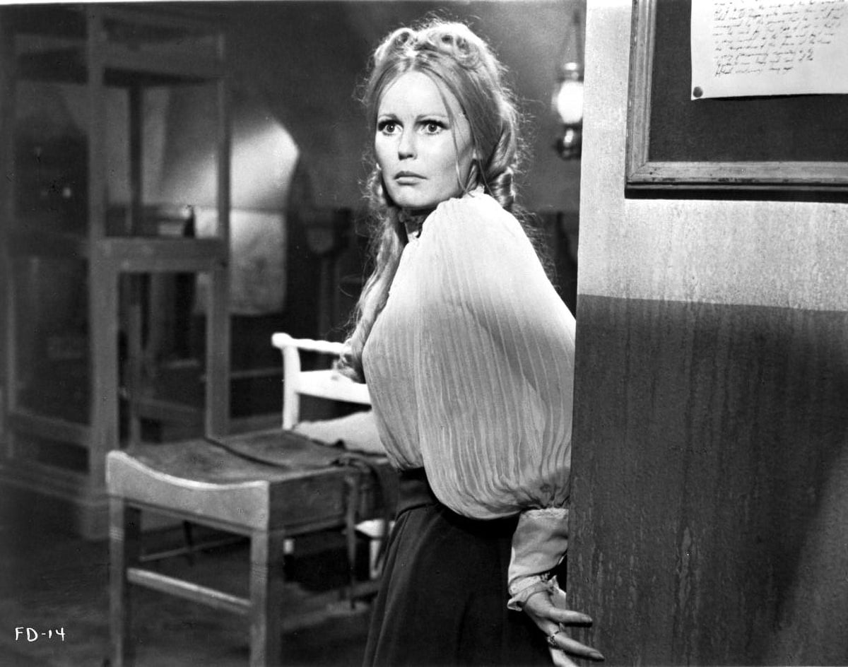 Veronica Carlson photo print in black skirt and draped top, elegant pose.