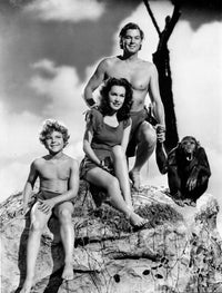 Johnny Weissmuller smiling in black and white photo print with monkey