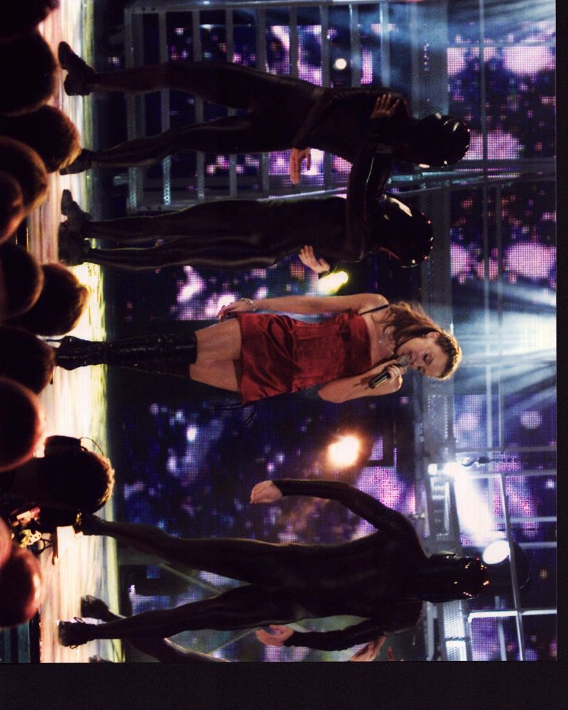 Kylie Minogue singing on stage in a red silk dress photo print.
