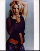 Britney Spears photo print in purple sheer shirt with arm raised.