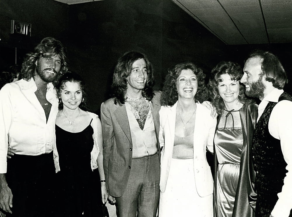 Candid group photo print of the Bee Gees, showcasing their iconic style.