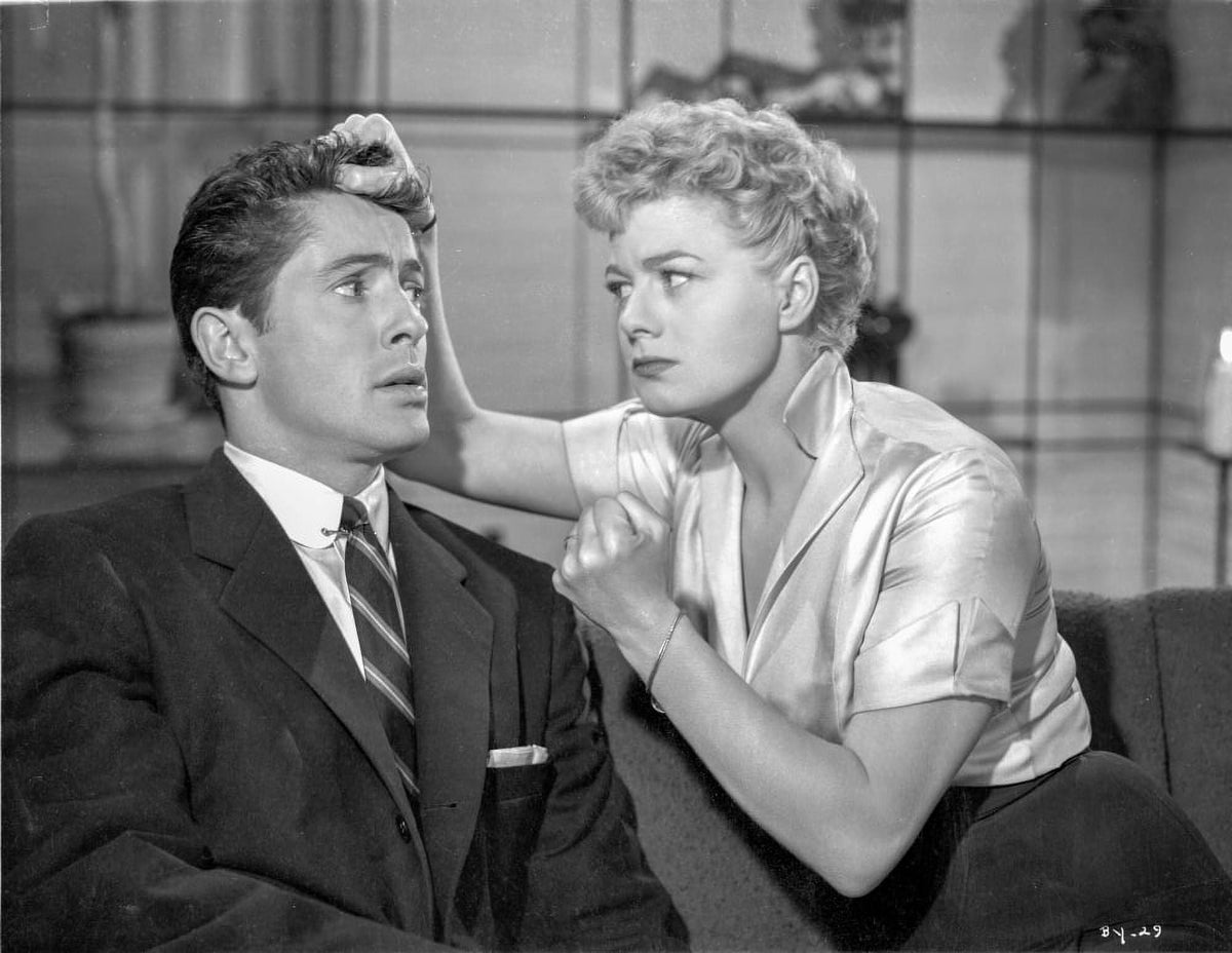 Dramatic photo print of a man in black suit facing a woman in white dress, capturing an intense moment.