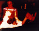 Juliette Lewis and Woody Harrelson sitting by a fire in Natural Born Killers photo print.