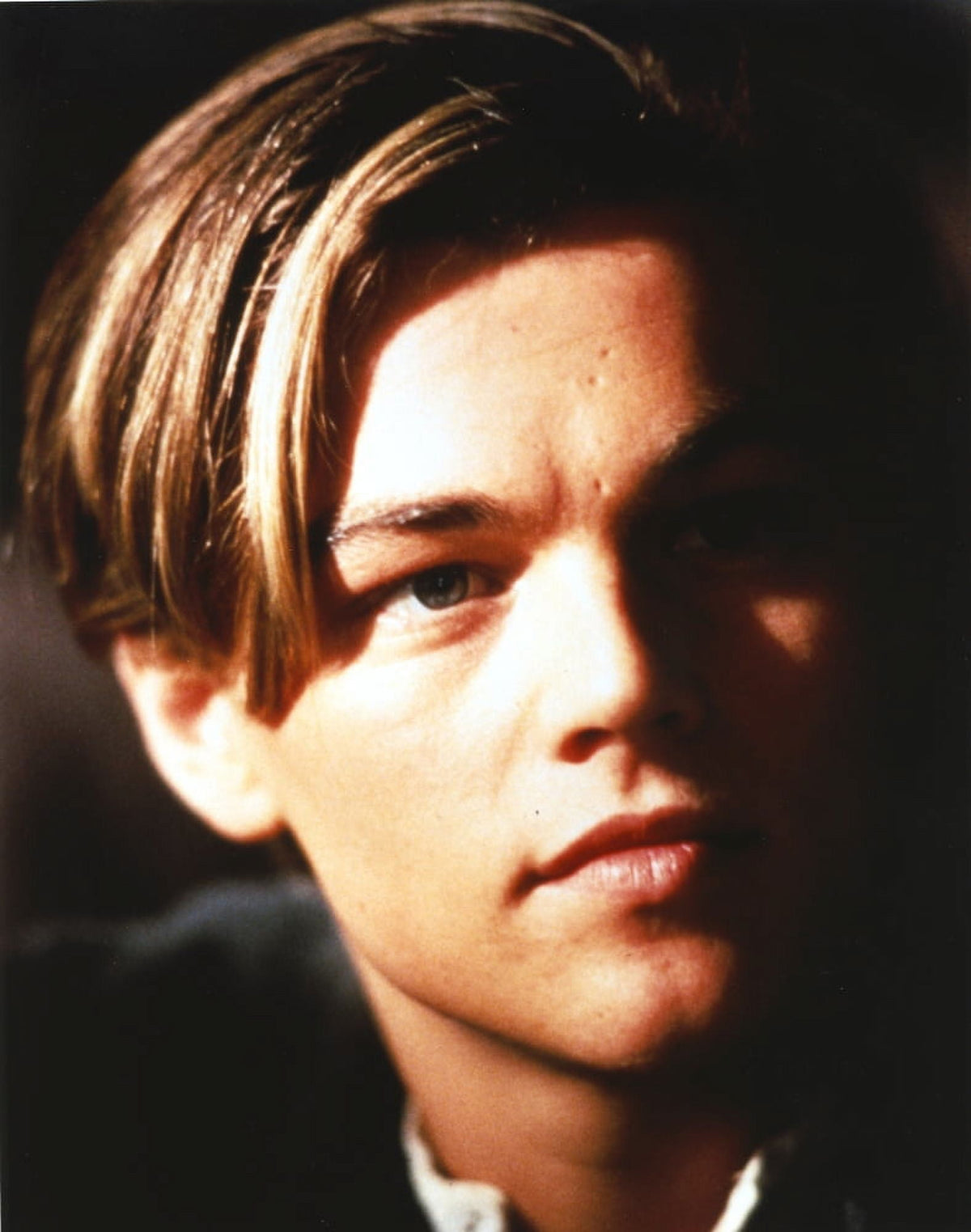 Close-up portrait photo print of Leonardo DiCaprio against a black background.