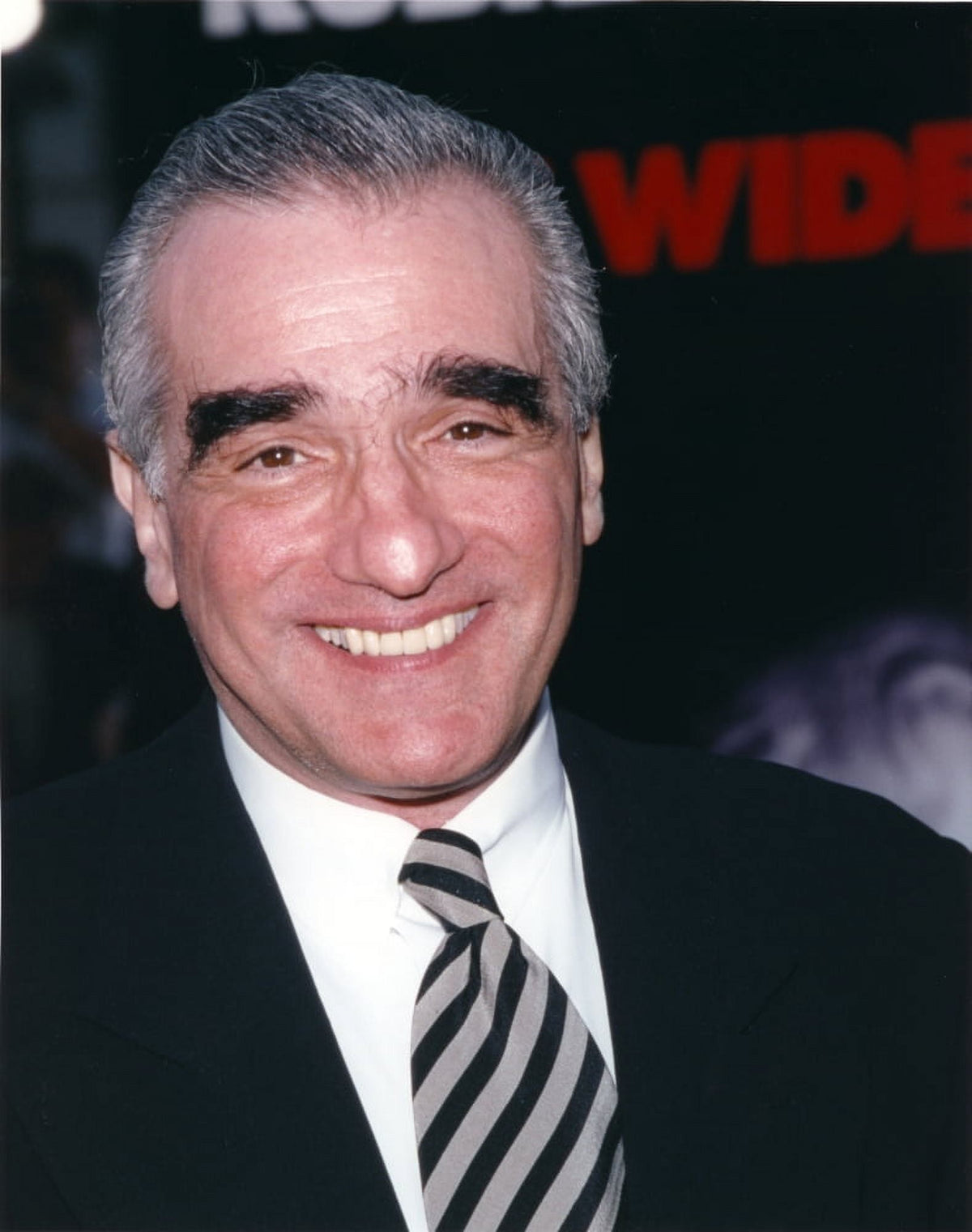 Close-up portrait of Martin Scorsese smiling in black suit and tie photo print