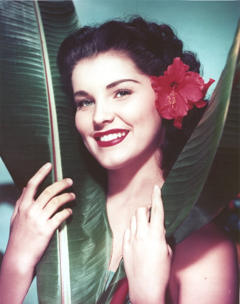 Close-up portrait of Debra Paget with flowers in her hair photo print