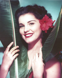 Close-up portrait of Debra Paget with flowers in her hair photo print