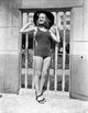 Vintage photo print of Betty Grable in swimsuit and black hat.