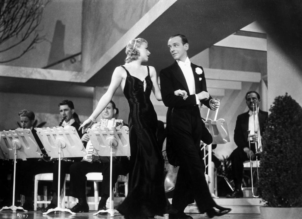 Fred Astaire and Ginger Rogers walking in front of orchestra photo print