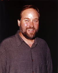 Richard Karn smiling in black shirt photo print