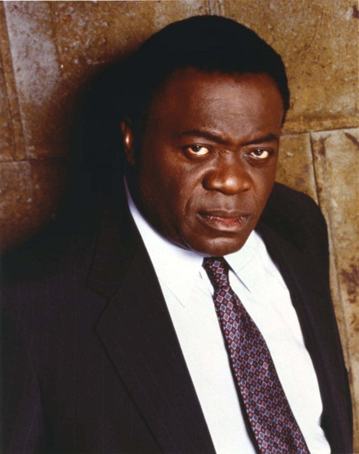 Yaphet Kotto pointing in a black suit photo print