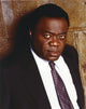 Yaphet Kotto pointing in a black suit photo print