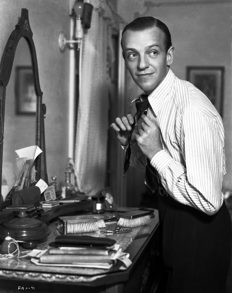 Fred Astaire fixing his neck tie photo print.
