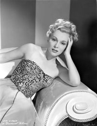 Eva Gabor sitting on a couch photo print.