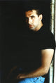 William Baldwin posed in a black t-shirt with a black background photo print.