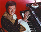 Liberace performing with pianist photo print in red background.