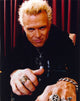 Billy Idol posed in black outfit with red curtain background photo print