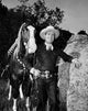 Gene Autry leaning on a big rock photo print