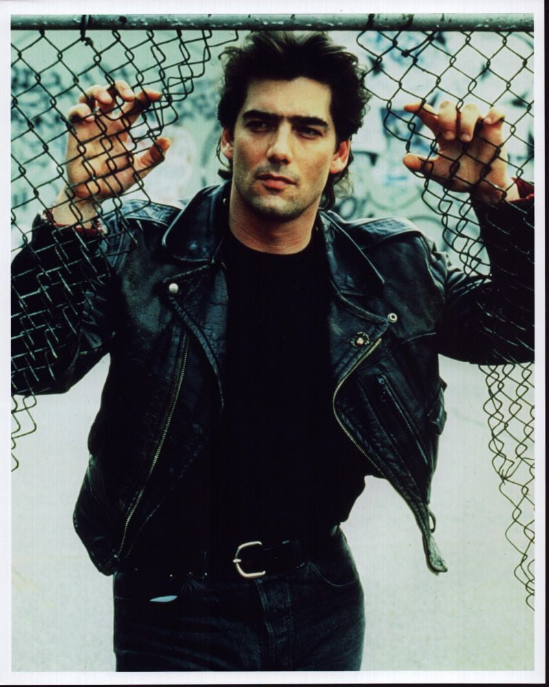Ken Wahl photo print in leather jacket leaning on fence
