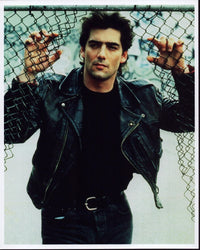 Ken Wahl photo print in leather jacket leaning on fence