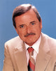 William Daniels formal suit portrait photo print with blue background.