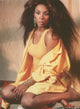 Donna Summer portrait photo print in yellow outfit, capturing the essence of disco.