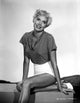 Beverly Michaels sitting and smiling portrait photo print.