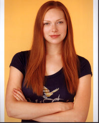 Laura Prepon photo print with crossed arms on yellow background.