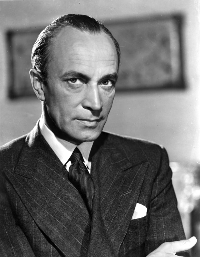 Conrad Veidt posed in a black suit, classic photo print.