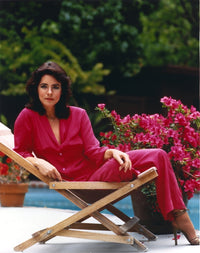 Stockard Channing seated elegantly in a red dress photo print