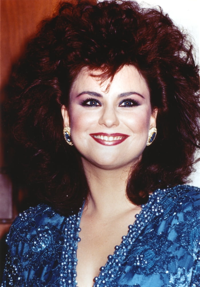 Delta Burke smiling in a glittery dress photo print