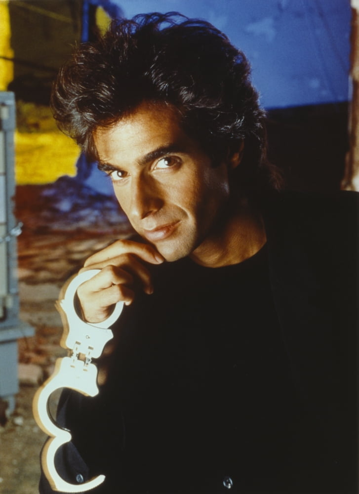 David Copperfield holding handcuffs photo print in black shirt