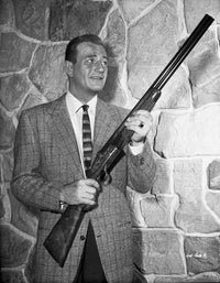 John Wayne photo print with rifle, classic Western icon.
